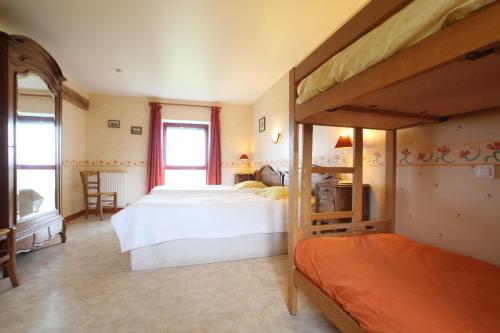 a bedroom with two beds and a window at Le Petit Manoir - Jean Gédouin in Servon