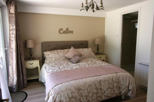 a bedroom with a bed and two night stands with lamps at Gite at 105 in Nampont-Saint-Martin