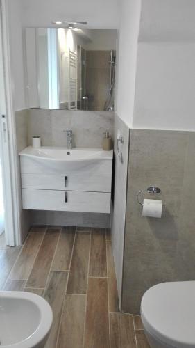 a bathroom with a sink and a toilet at Casa Ofelia in Levanto