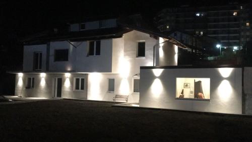 a white building with lights on it at night at Il Girasole in Saint Vincent