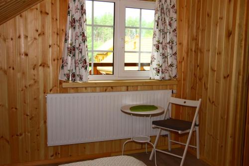 a room with a table and a window and a chair at Asvejos slenis in Sužionys