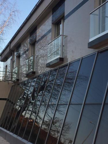 a building with glass windows on the side of it at Hotel Royal in Tetovo