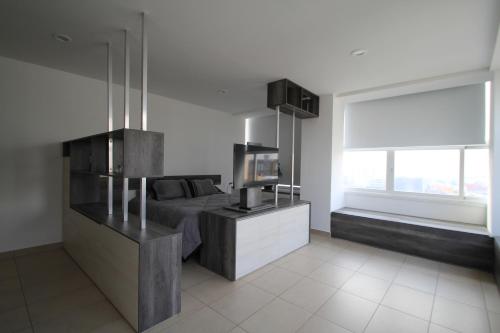 a bedroom with a bed and a television in it at Boutique Apartment Downtown 1506 in Mexico City