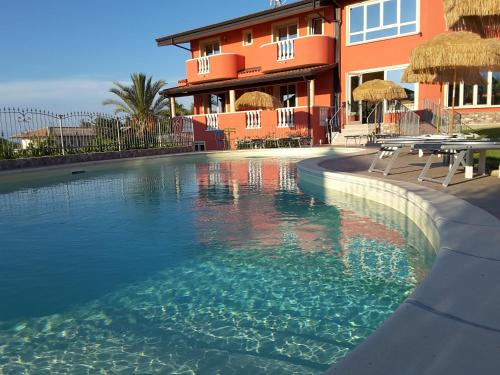 a swimming pool in front of a building at Borgo di Santa Barbara in Santa Domenica