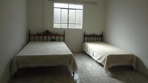 Säng eller sängar i ett rum på Hostel Mirante do Vale