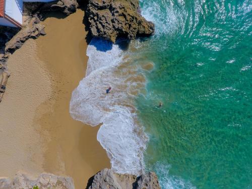 people swimming in the ocean on a beach at Caribbean Diamond Boutique Hotel in Sosúa