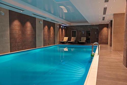 a large swimming pool in a hotel room at Orbi Bakuriani Apartment in Bakuriani