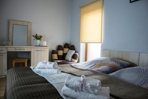 a bedroom with two beds with towels on it at Pokoje Staromiejski in Uniejow