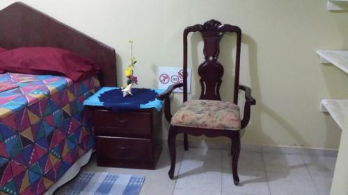 a chair sitting next to a bed next to a dresser at B&B KeisyAlba Punta Rucia in Punta Rucia