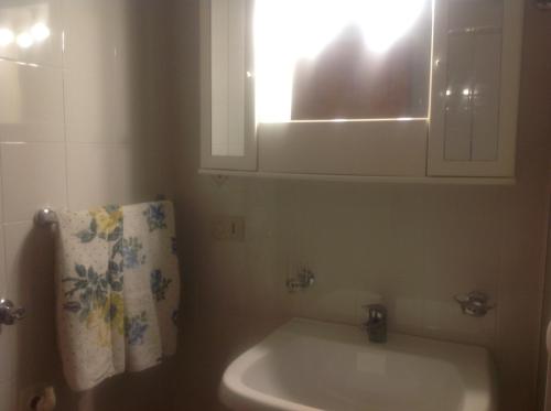 a bathroom with a sink and a mirror and a towel at fabrizio e caterina in San Vito lo Capo