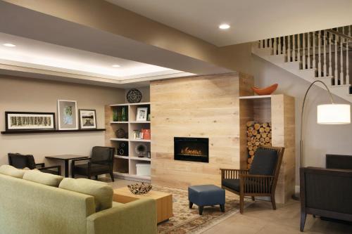 a living room with a couch and a fireplace at Country Inn & Suites by Radisson, Atlanta Airport North, GA in Atlanta