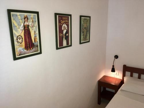 a bedroom with three framed posters on the wall at Pousada Atlantis in Jericoacoara