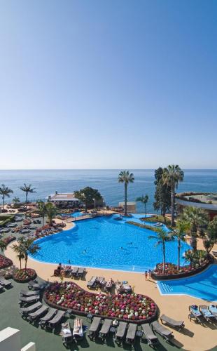 an overhead view of a swimming pool at a resort at Pestana Carlton Madeira Ocean Resort Hotel in Funchal