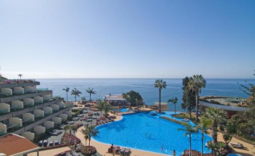 an aerial view of a resort with a swimming pool at Pestana Carlton Madeira Ocean Resort Hotel in Funchal