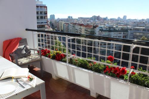 a balcony with flowers and a view of a city at Quad Avenue in Lisbon