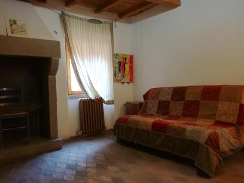 a bedroom with a bed and a fireplace at Casamatta a Blera in Blera