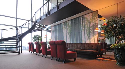 a waiting room with a couch and chairs in a building at Pestana Carlton Madeira Ocean Resort Hotel in Funchal