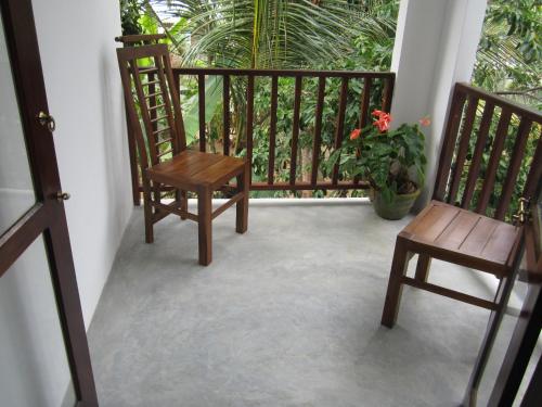 two chairs and a table on a balcony at Arazo villa in Unawatuna