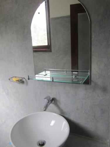 a bathroom with a sink and a mirror at Arazo villa in Unawatuna