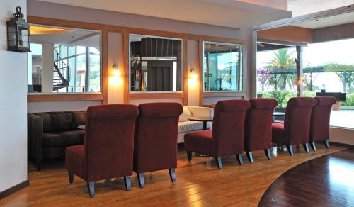 a living room with a table and chairs and a couch at Pestana Carlton Madeira Ocean Resort Hotel in Funchal