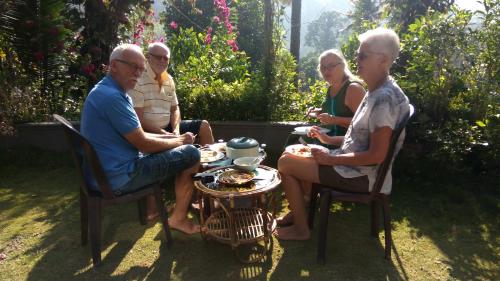 a group of people sitting around a table at Thoppil Homestay Munnar in Munnar
