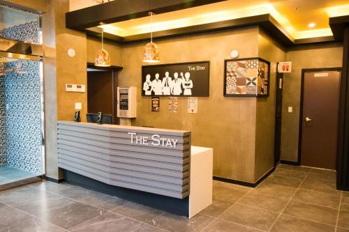 a lobby of a store with a sign that reads the stay at Yeosu Thestay Hostel in Yeosu