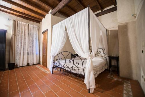 a bedroom with a bed with a canopy at Bernardone in Camaiore