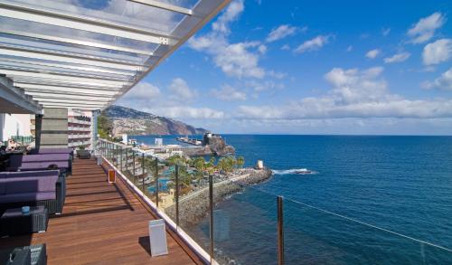 a balcony with a view of the ocean at Pestana Carlton Madeira Ocean Resort Hotel in Funchal