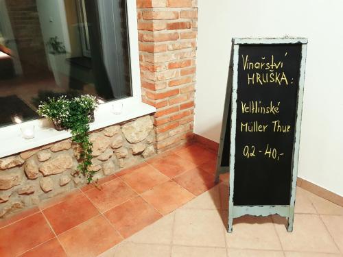 a chalkboard sign in front of a building at Hotel Dvůr in Krnsko