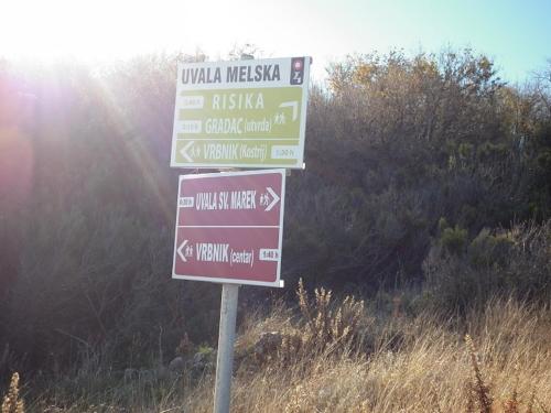 a street sign in the middle of a field at Holiday Home with Sea View in Vrbnik