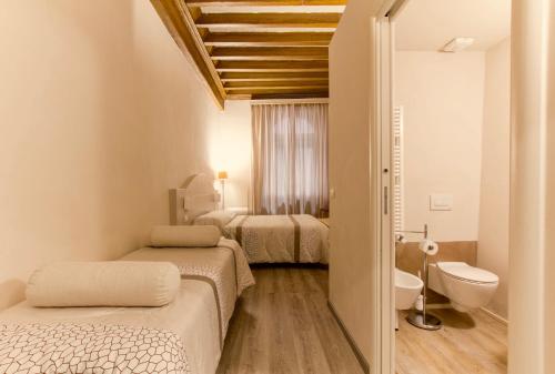 Ένα ή περισσότερα κρεβάτια σε δωμάτιο στο Le Camere di Caterina