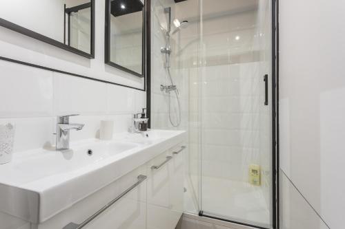 a white bathroom with a sink and a shower at Gare Saint Roch - Podshare in Montpellier