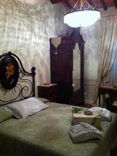 a bedroom with a bed with a canopy and a mirror at B&B Al Re in Cesena