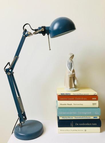 a lamp sitting on a stack of books with a doll on top at Herberg Swaen aan de Brink in Den Ham