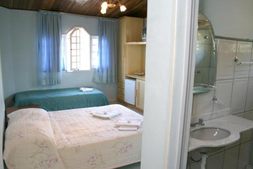 Säng eller sängar i ett rum på Pousada Bariloche