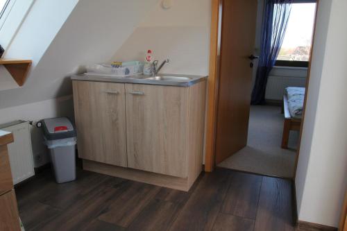 a small bathroom with a sink and a staircase at Ferienwohnung Hamberge in Hamberge