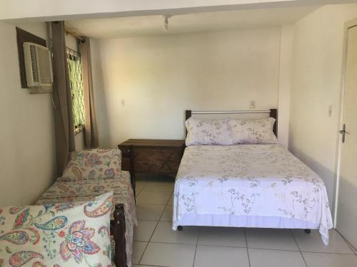 a bedroom with two beds and a window at Canto da Praia in Itajubá