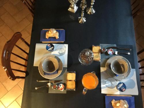 a table with plates and cups and food on it at Villa Niccoli in Castelfiorentino