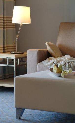 a living room with a couch and a table with a lamp at Pestana Carlton Madeira Ocean Resort Hotel in Funchal