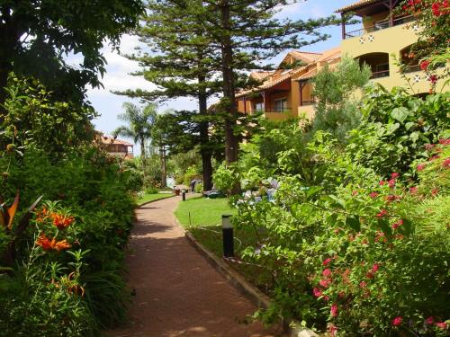 a street scene with trees and bushes at Pestana Village Garden Hotel in Funchal