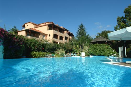 a swimming pool in front of a building at Pestana Village Garden Hotel in Funchal
