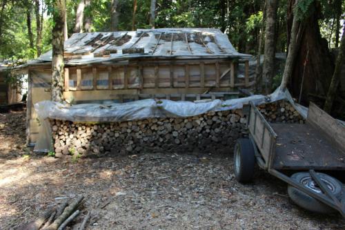 an old building with a cart in front of it at Cabaña Rustica Patagonia Chilena in Coñaripe