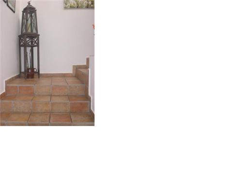 a staircase in a house with a tile floor at Apartman JITKA Protivin in Protivín
