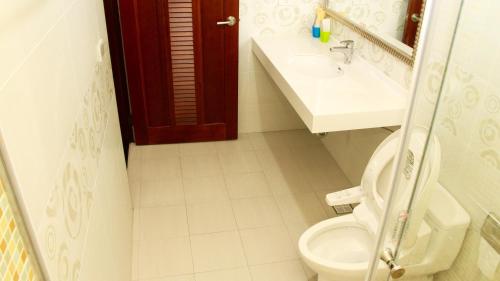 y baño con aseo y lavamanos. en Home of 120 B&B, en Jiaoxi
