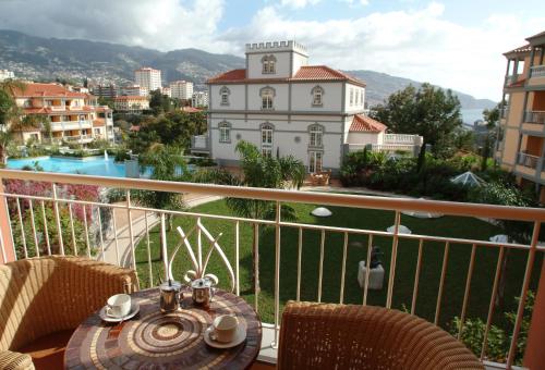 
a large stone building with a balcony overlooking a river at Pestana Miramar Garden & Ocean Hotel in Funchal
