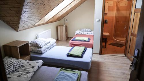 una piccola stanza con tre letti e un bagno di Gospodarstwo Agroturystyczne Milejewko a Milejewo