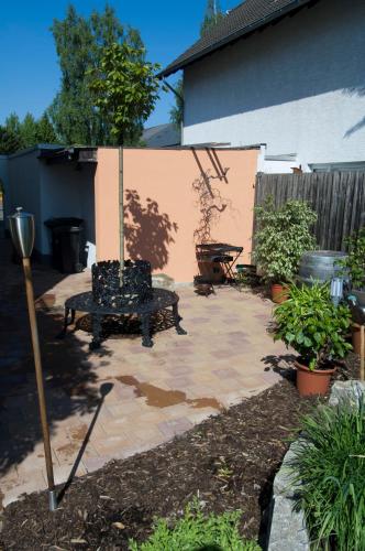 a patio with a bench in a yard at FeWo-Schwarzer in Ingelheim am Rhein