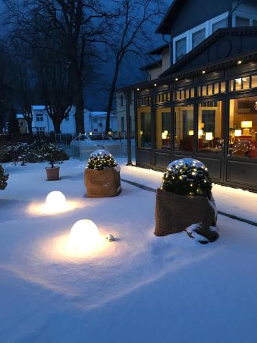 a group of lights in the snow in front of a building at Hotel Sonneneck in Zinnowitz