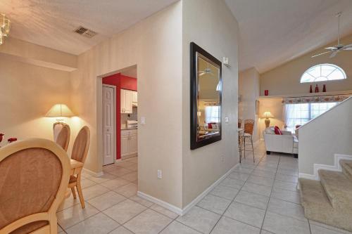 a living room with a dining room and a kitchen at Mickey's Lake Villa in Orlando