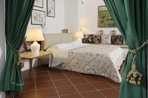 a bedroom with a bed with green curtains at ANTICA VILLA La Viola, Suite with private pool in Lecce